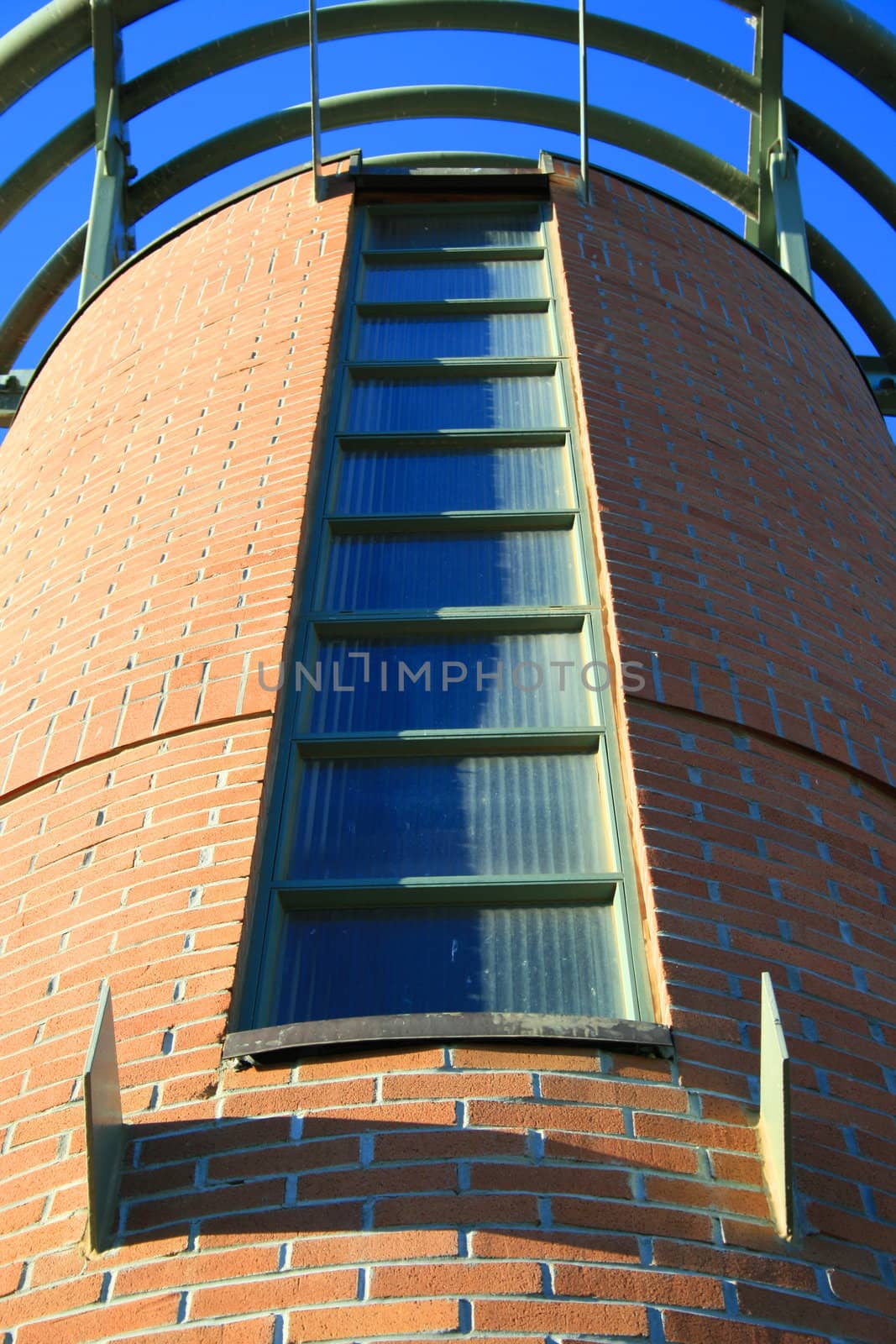 Close up of a tall tower over blue sky.
