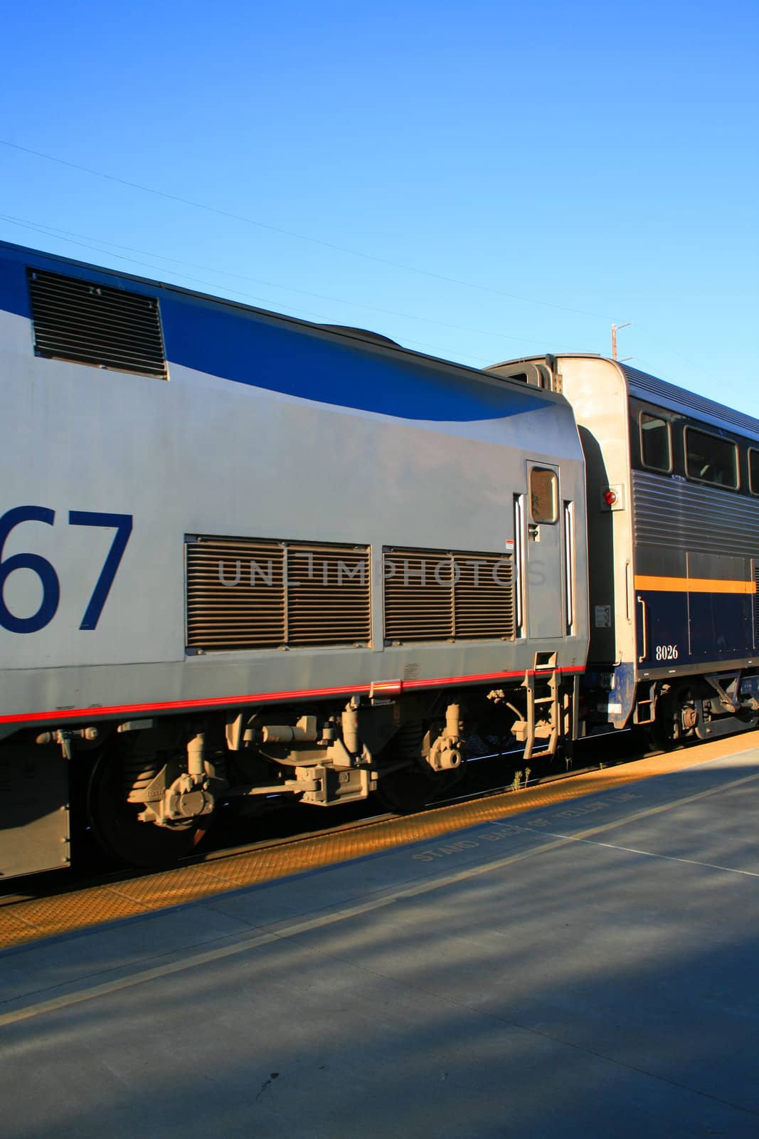 Passenger train parked at a train yard.
