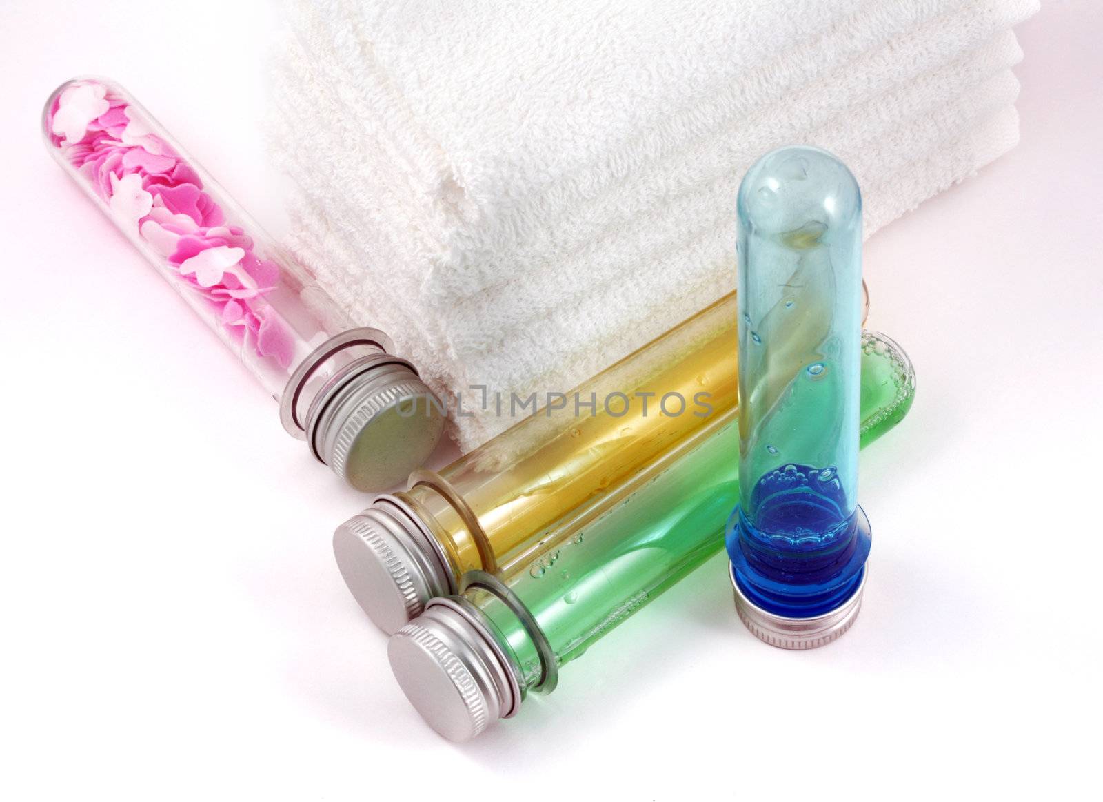 White towels and four bottles with shampoo