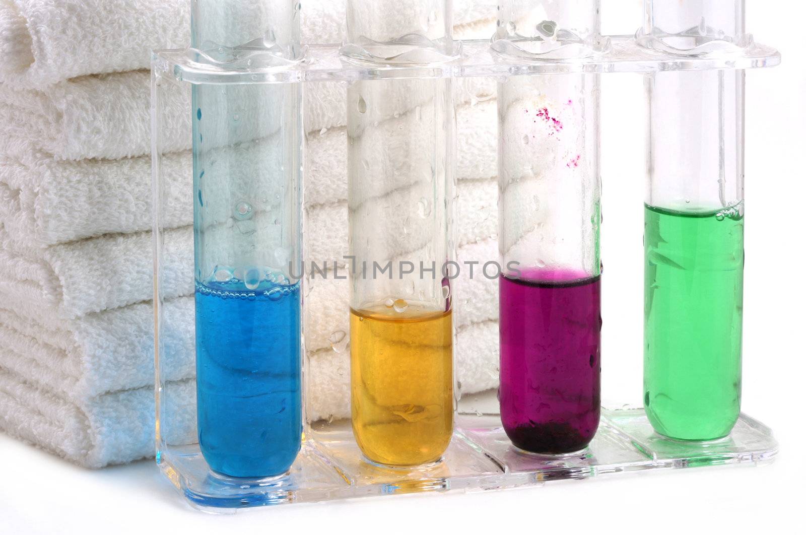 White towels and four bottles with shampoo