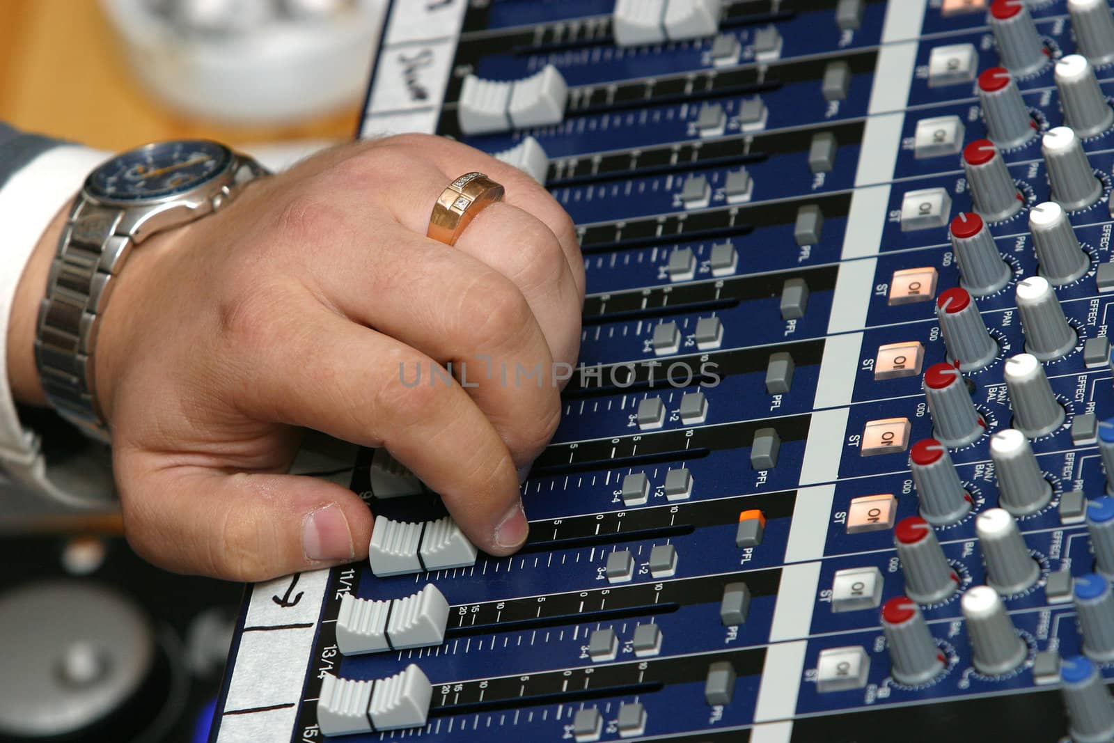 The image of a man's hand managing the musical board