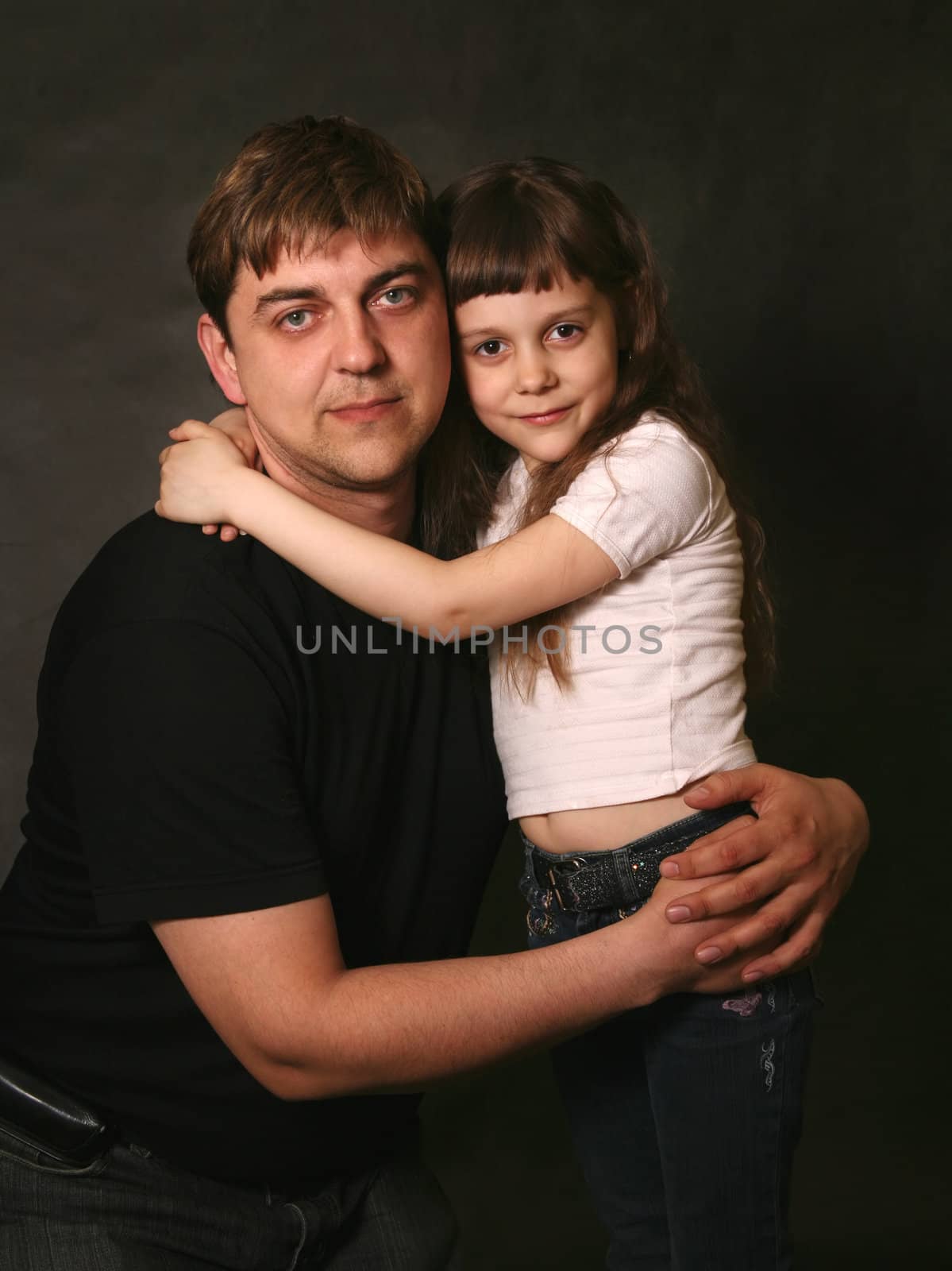 Double portrait. The daughter embraces the father