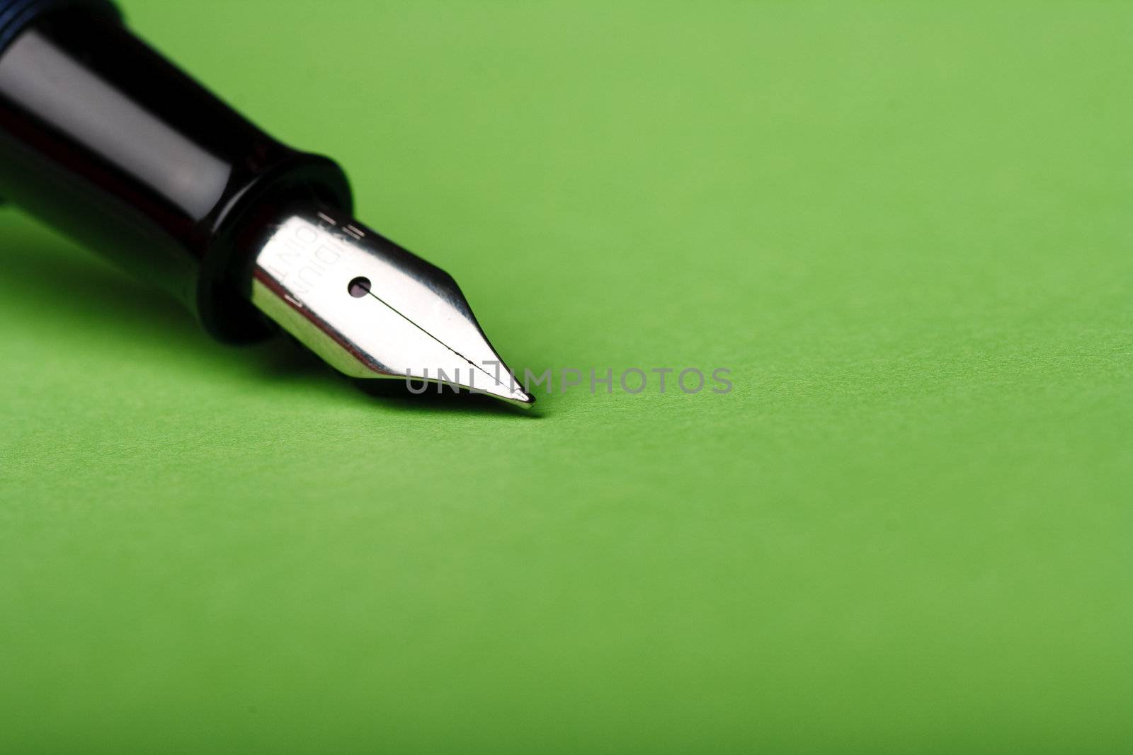 Macro isolated fountain pen on green background