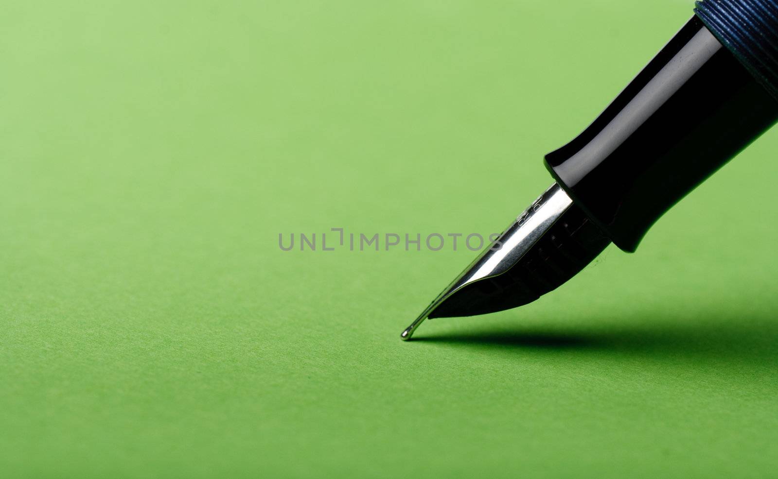 Macro isolated fountain pen on green background