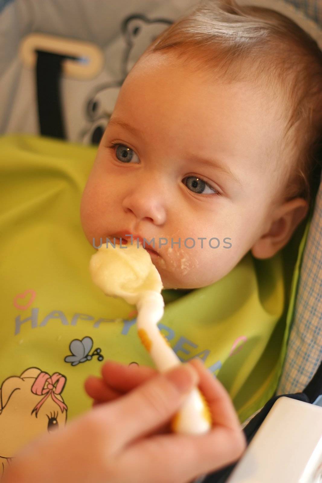 The parent feeds the little child