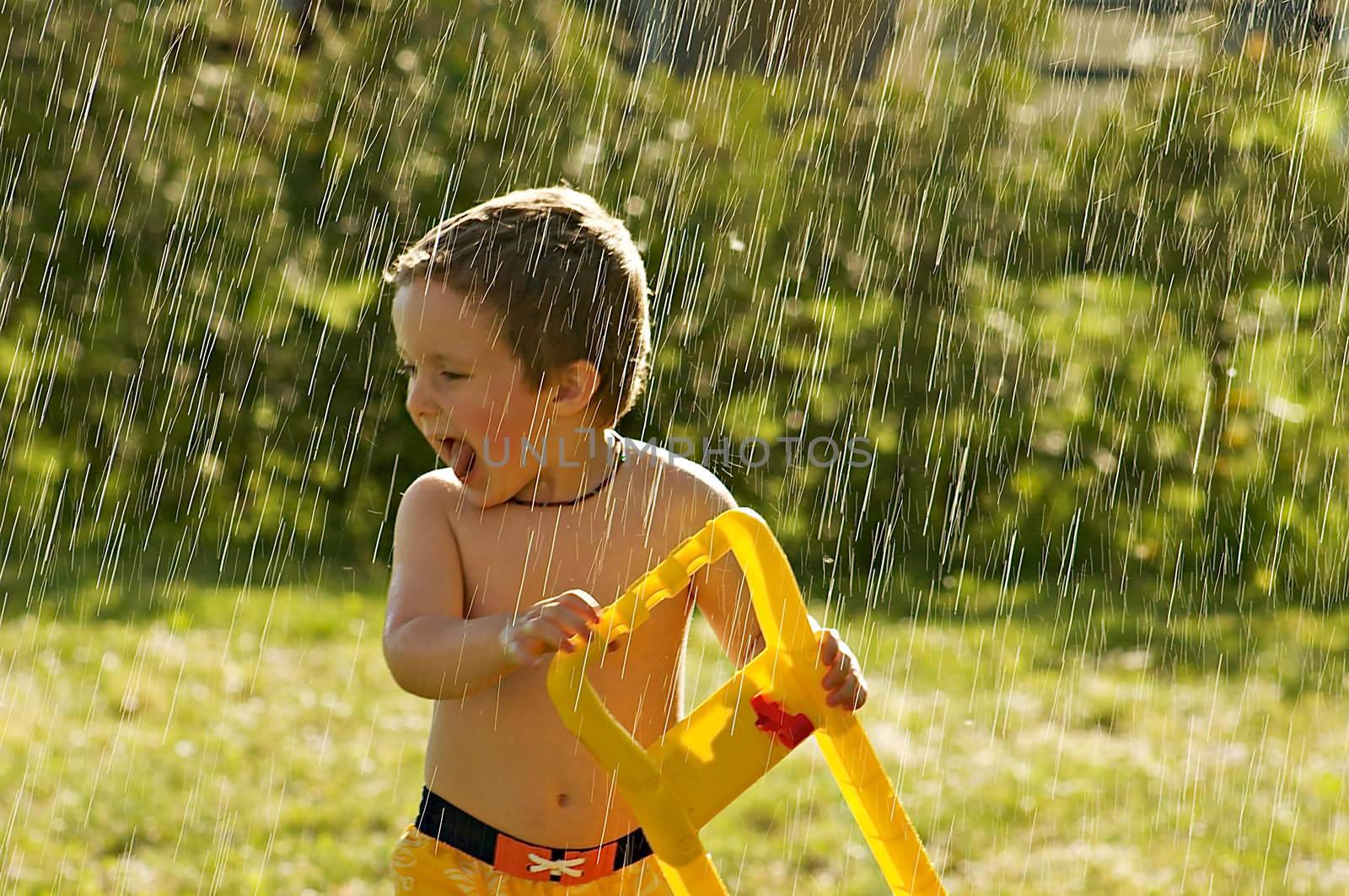 Little boy caught in the rain while playing outside