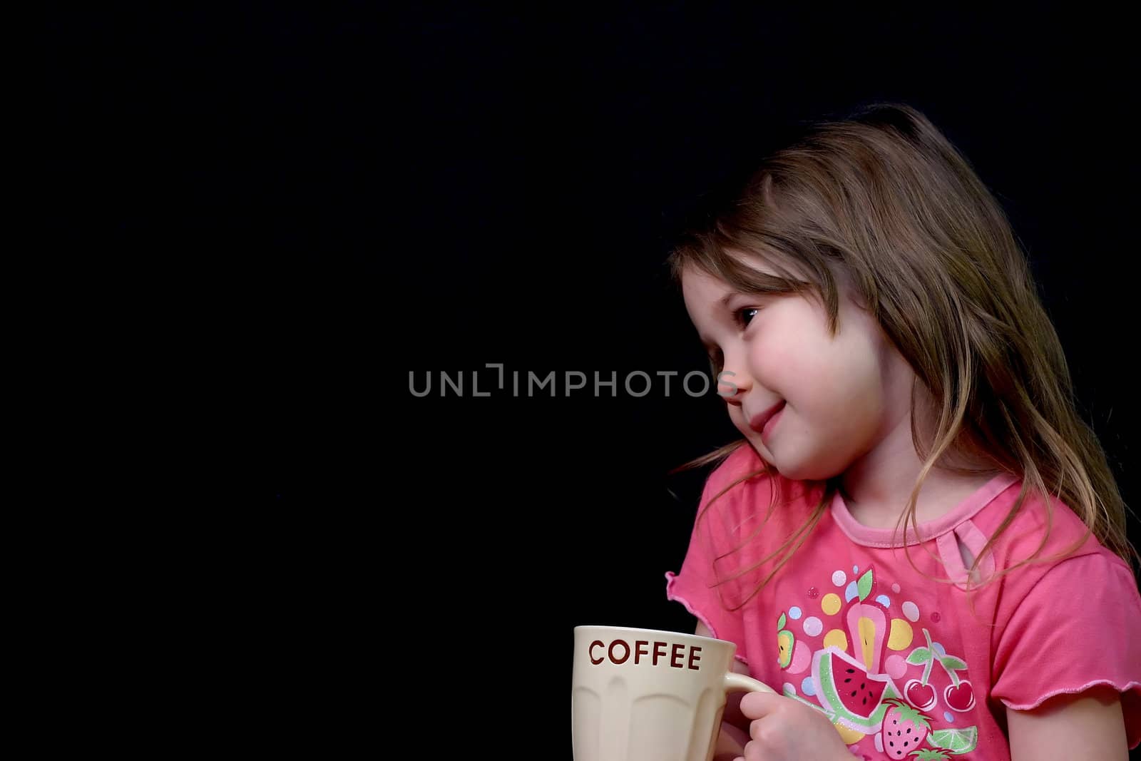 Little girl holding a cup of coffee