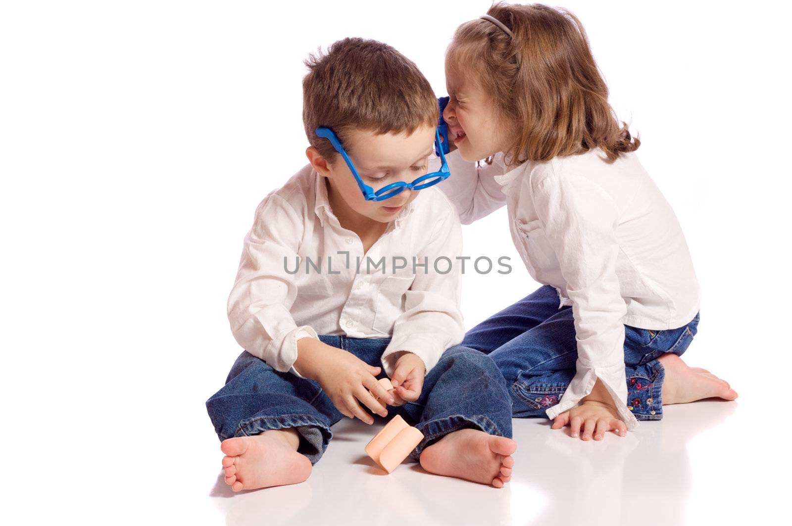 Cute little brother and sister playing doctor