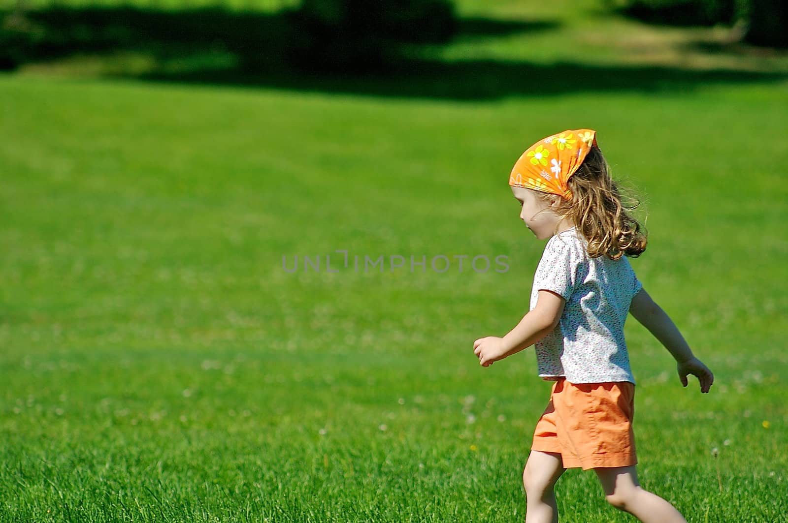 Little girl on grass by Talanis