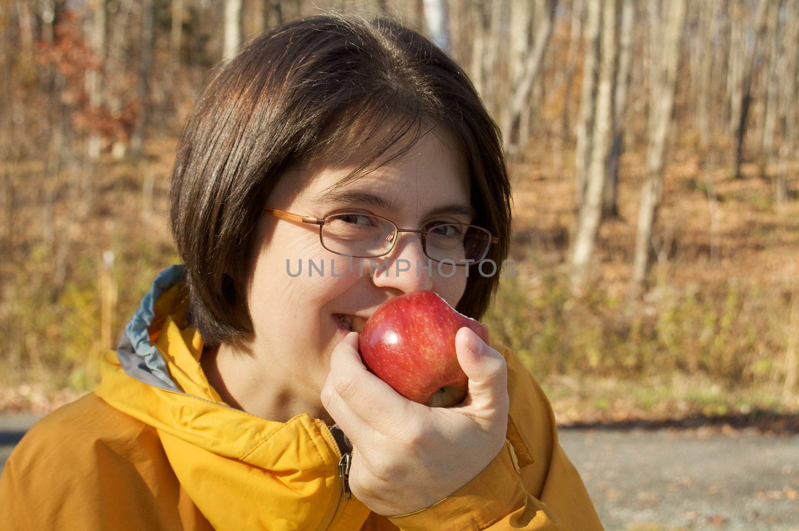 Cute young woman eating an apple