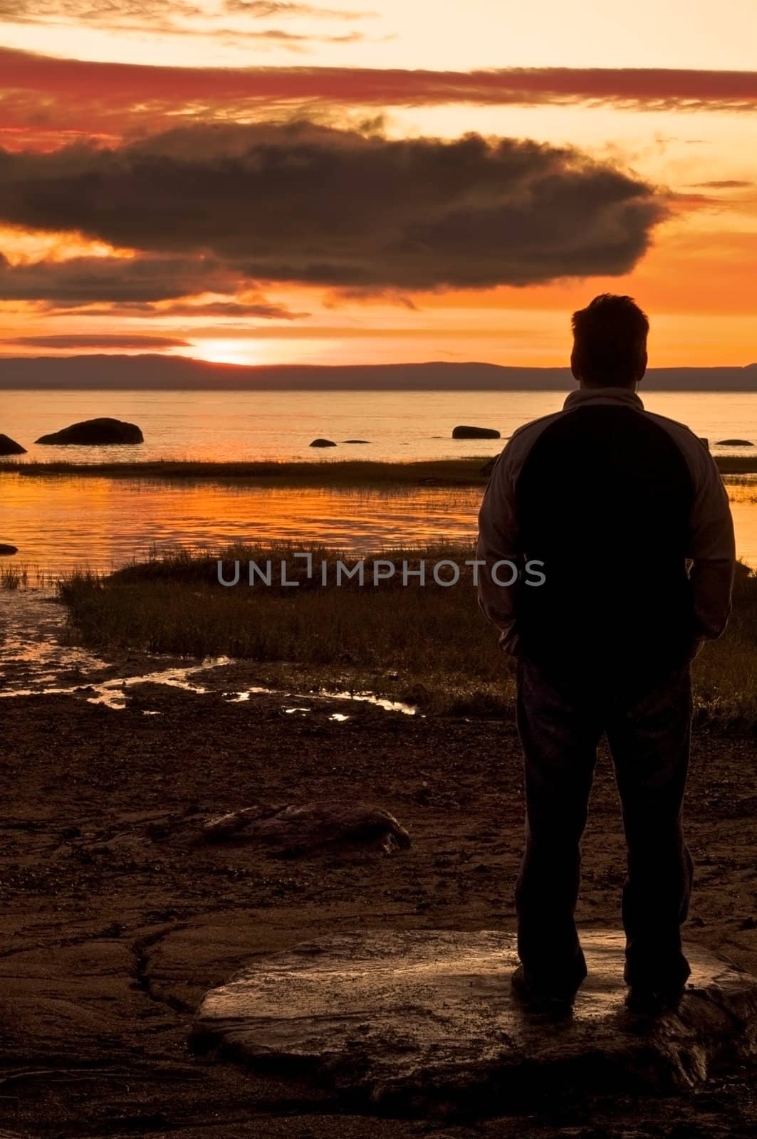 Man sitting and watching a beautiful sunrise