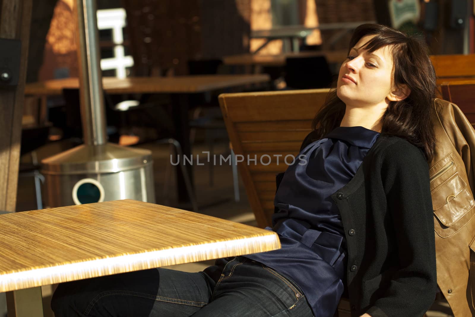 young woman sitting at a table in a cafe