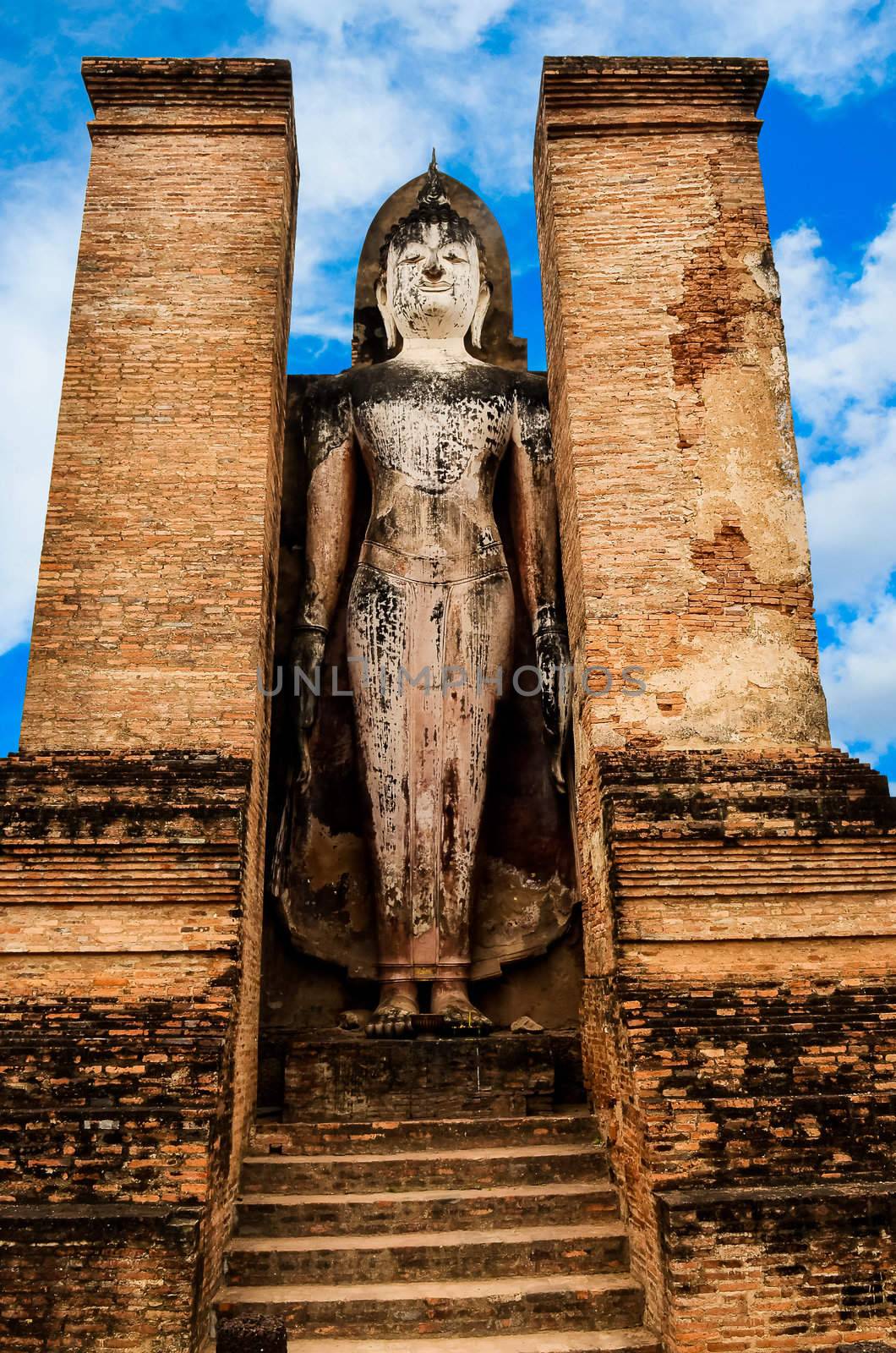 Statue of standing Buddha in Sukhothai historical park, Thailand by martinm303