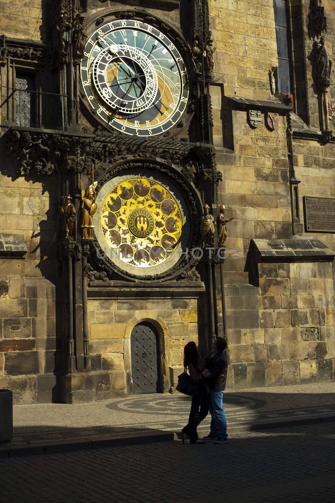 young couple on the background of astronomical clock in Prague by jannyjus