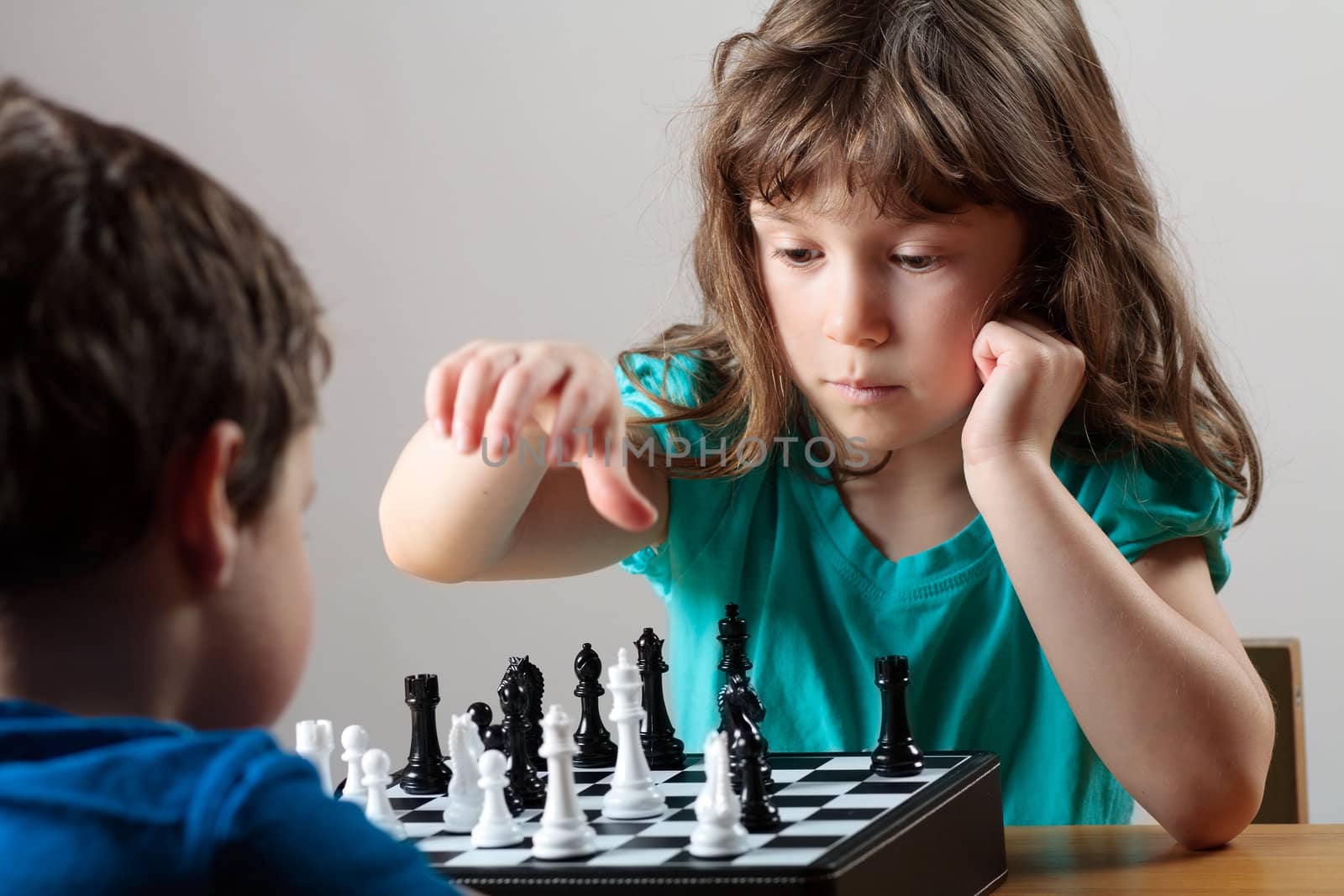 Cute little girl playing chess by Talanis