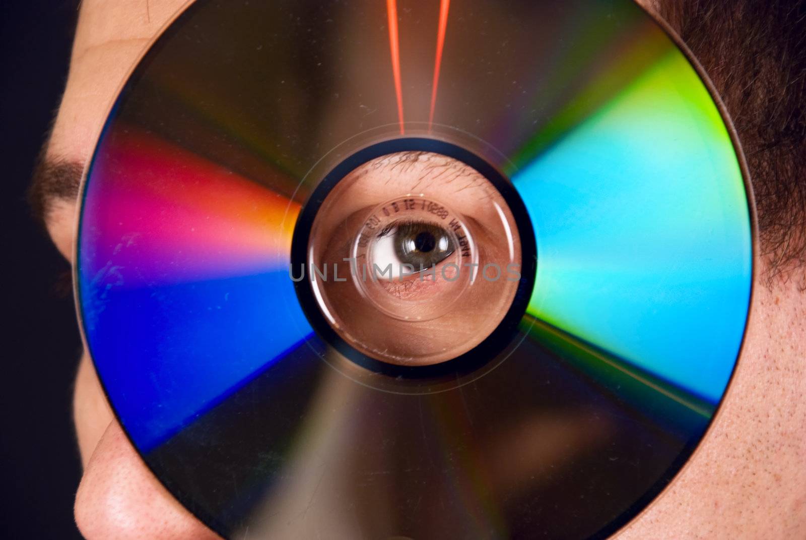 portrait of a man looking through a CD