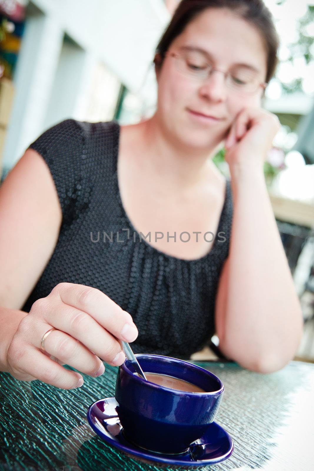 Woman having a coffee outside a restaurant