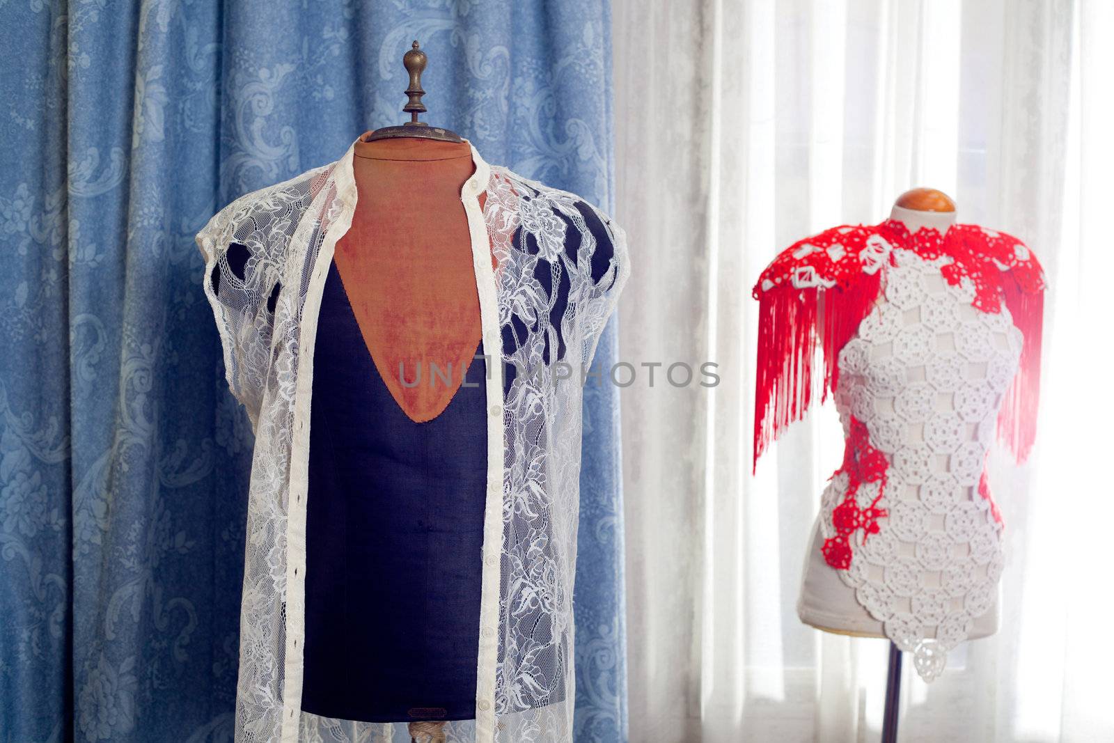 dressmakers and taylor mannequin with fashion clothes and curtain background