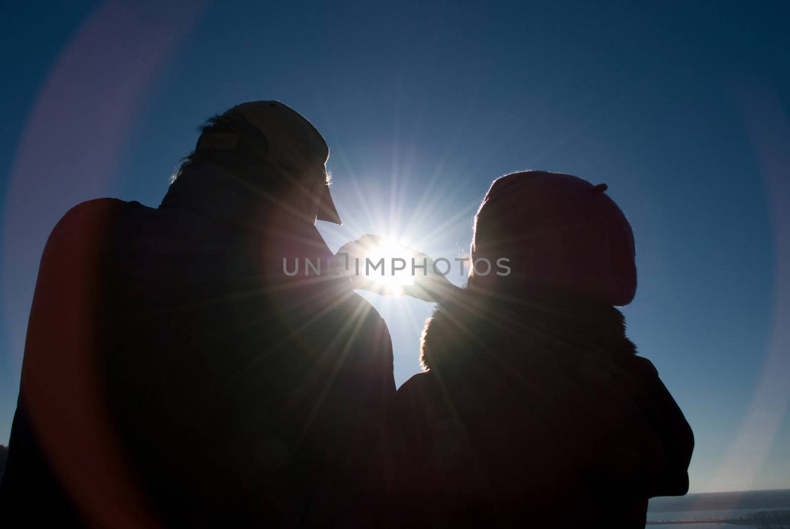 man and a woman holding a sun
