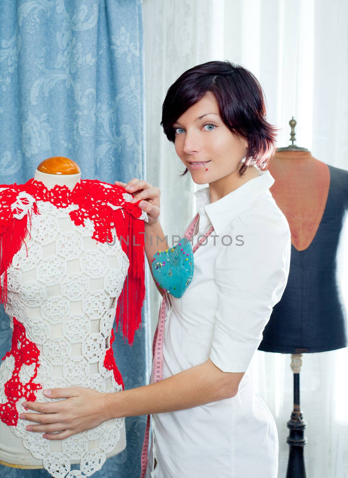 Dressmaker with mannequin as professional fashion designer