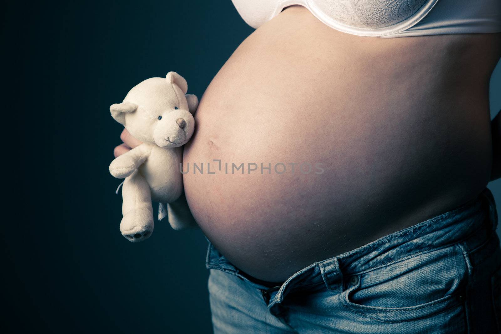 Pregnant woman torso with a teddy (vintage look)