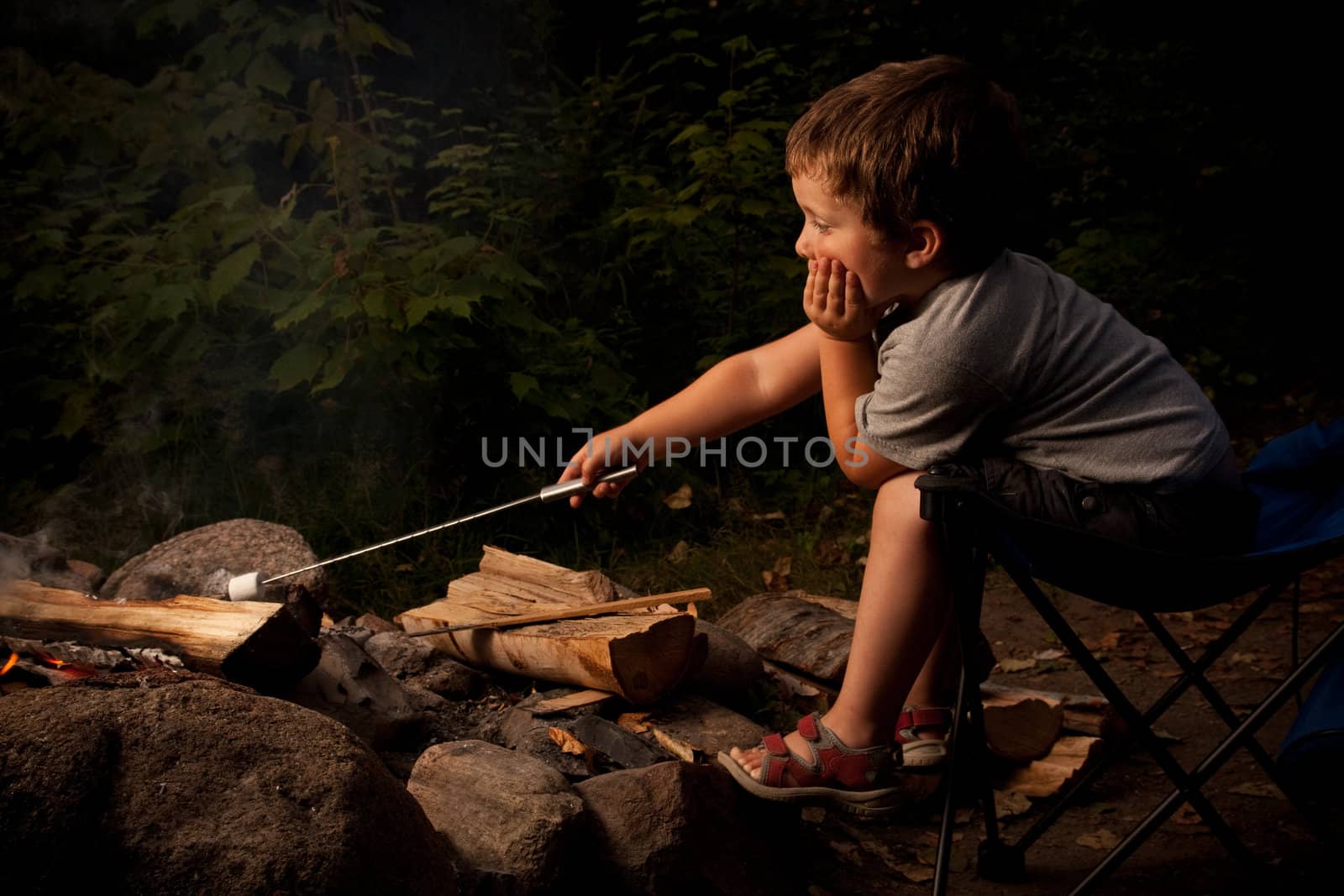 Boy cooking marshmallow by Talanis