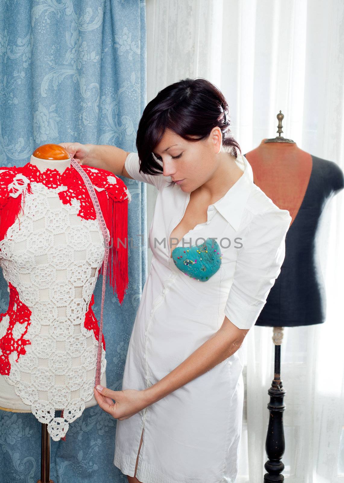 Dressmaker with mannequin as professional fashion designer