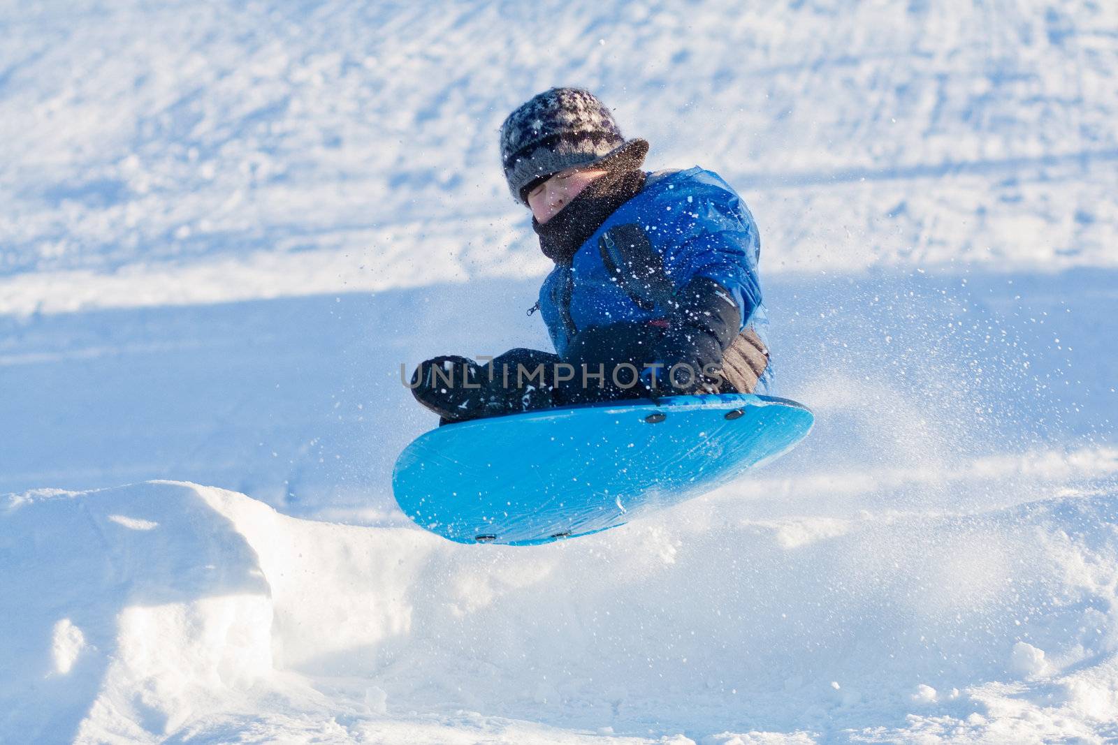Winter fun - Boy sliding by Talanis
