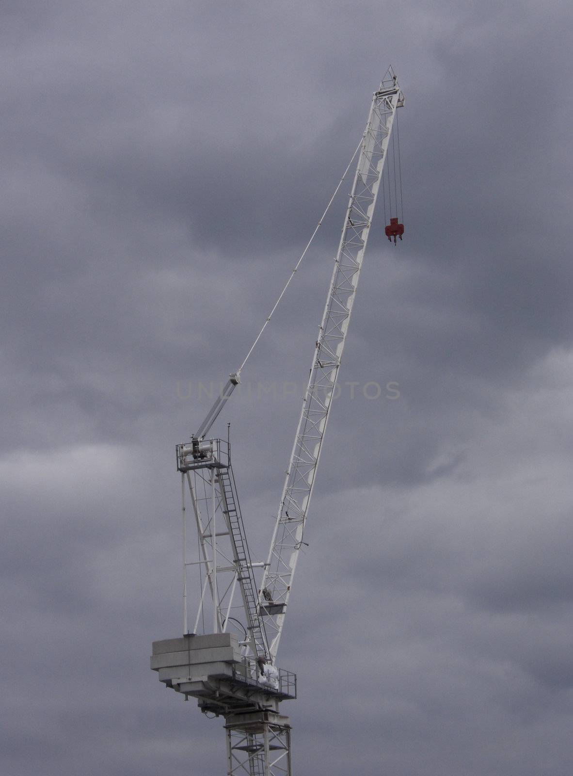 Tower crane against a cloudy sky.
