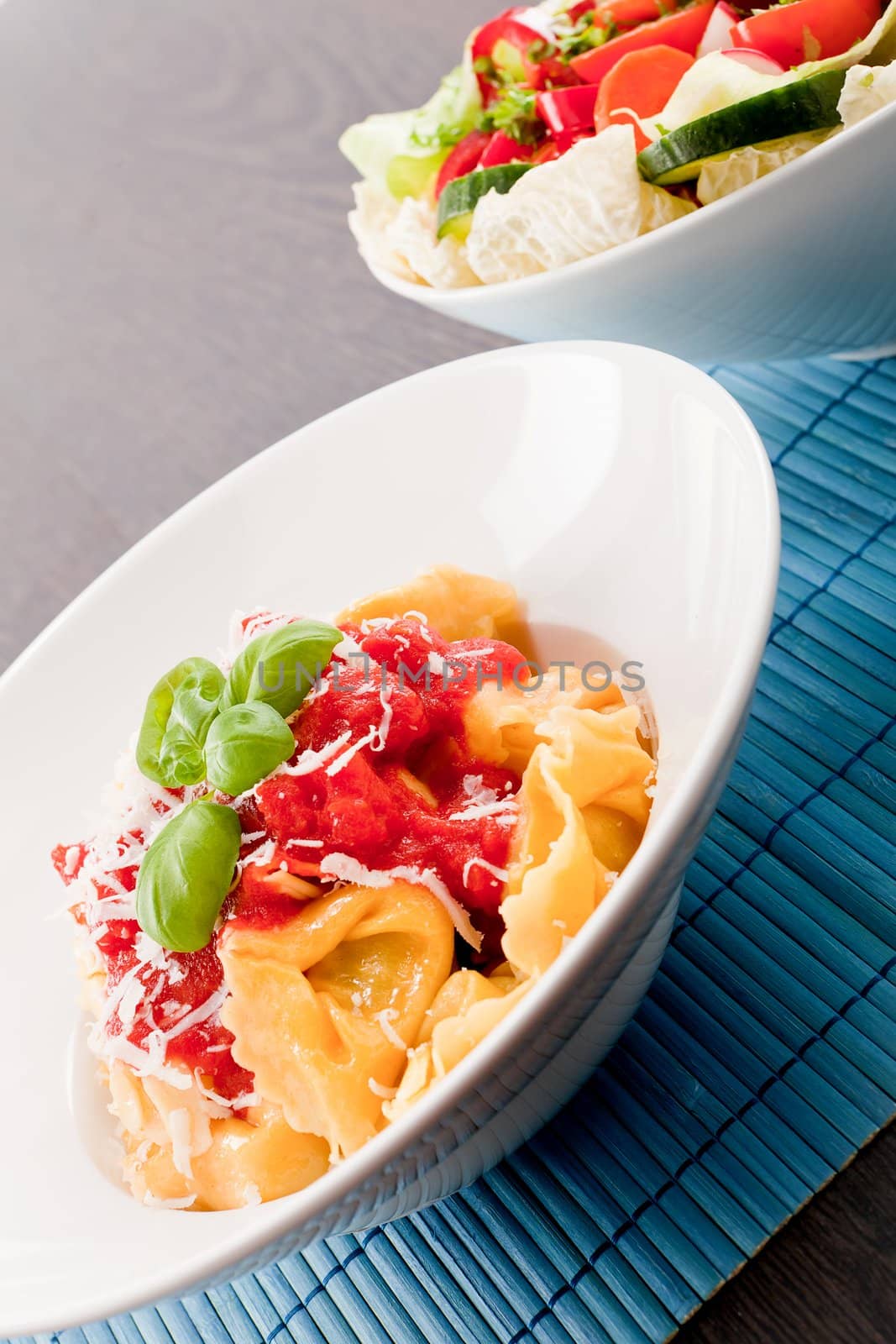 tasty fresh homemade ravioli with tomato sauce basil and parmesan