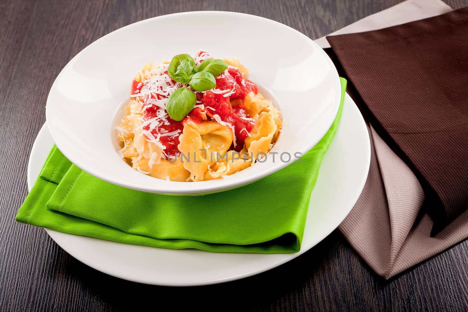 tasty fresh homemade ravioli with tomato sauce basil and parmesan