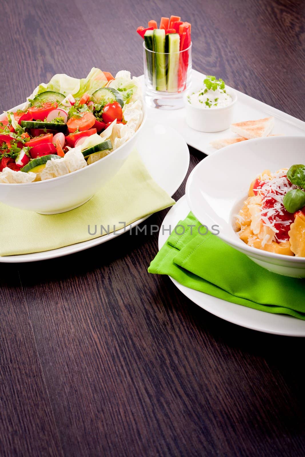collection of different plates with healthy food pasta salad vegetables on wooden table