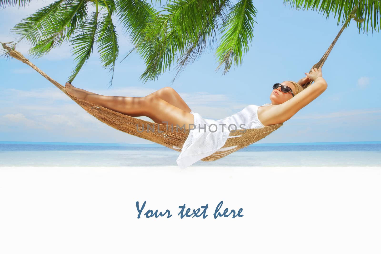 view of nice young lady swinging  in hummock on tropical beach by ersler