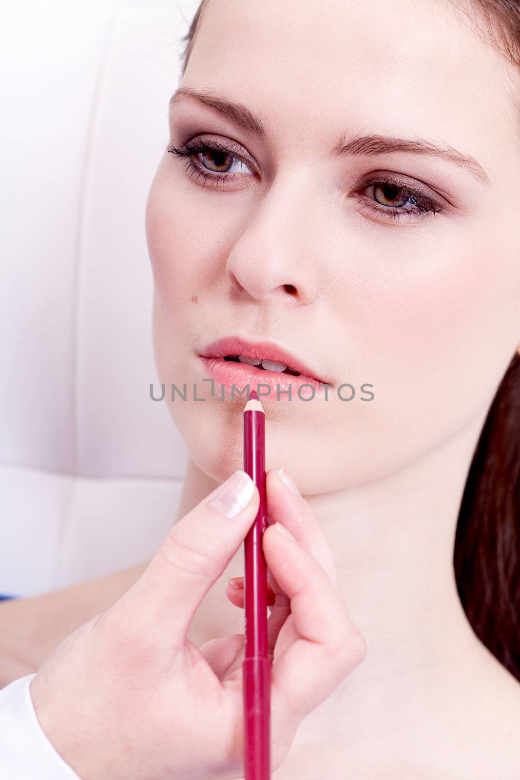 lipliner on lips attractive brunette woman in cosmetic studio beauty salon
