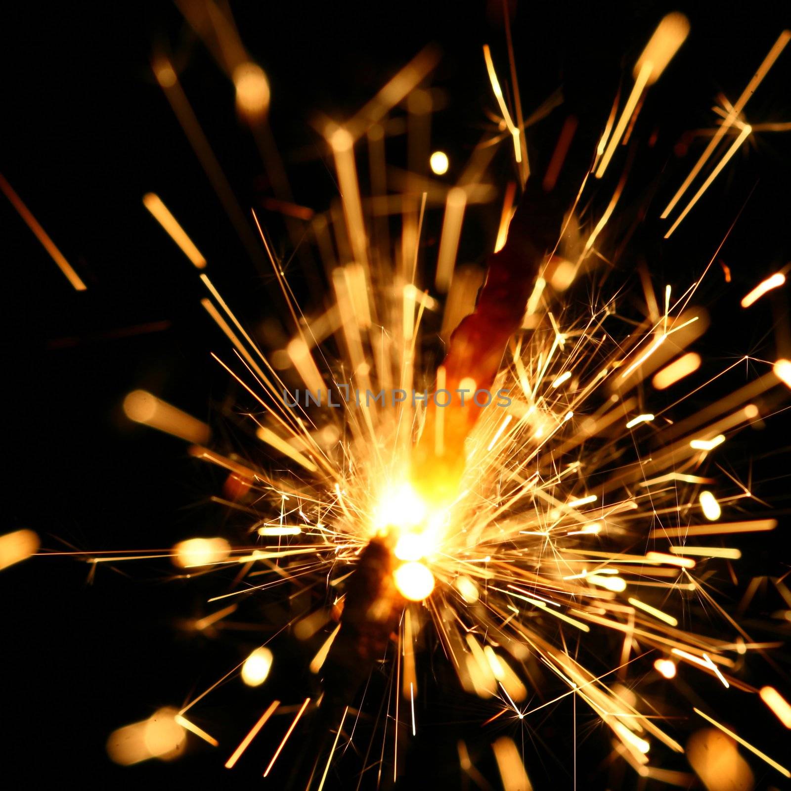 yellow sparkler holiday background on black