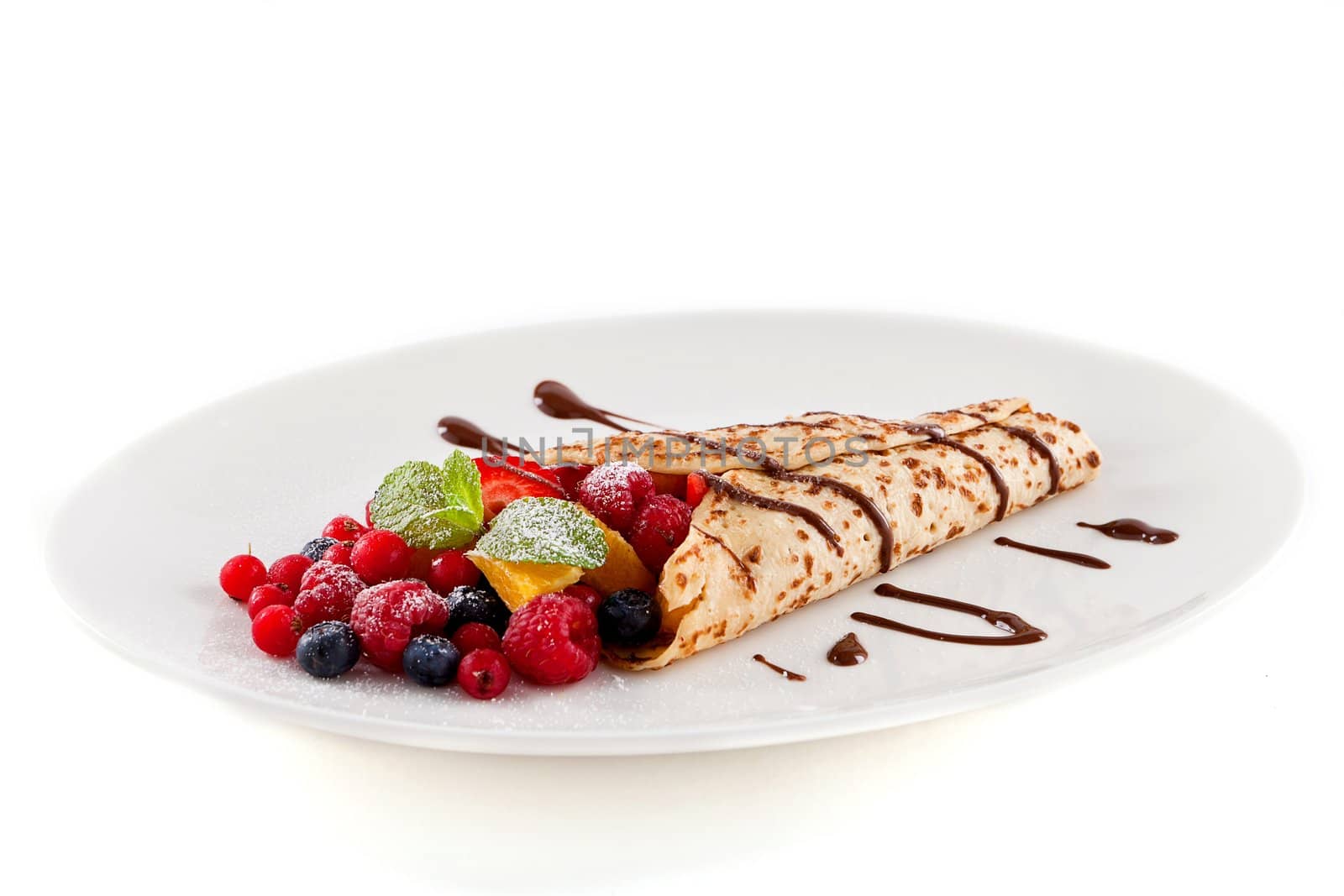 fresh tasty homemade crepe pancake with chocolate sauce fruits and berries