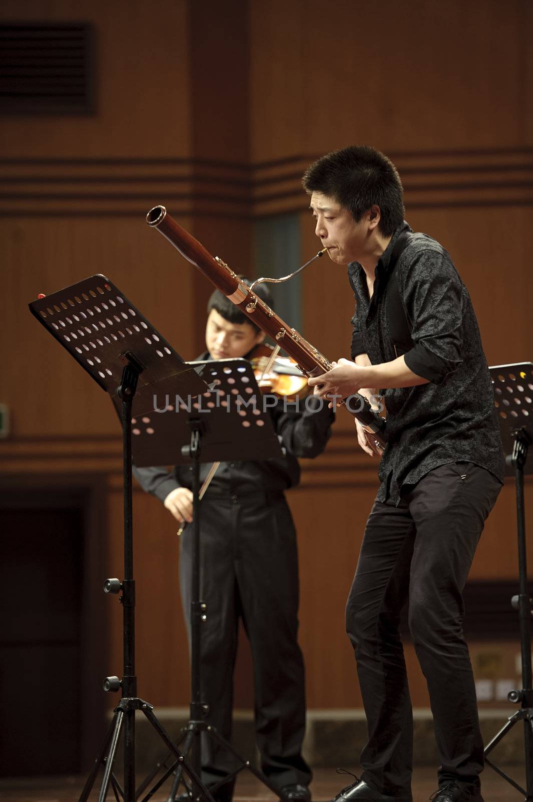 CHENGDU - JUN 20: bassoonist perform on wind music chamber music concert at odeum of Sichuan Conservatory of Music on Jun 20,2012 in Chengdu,China.