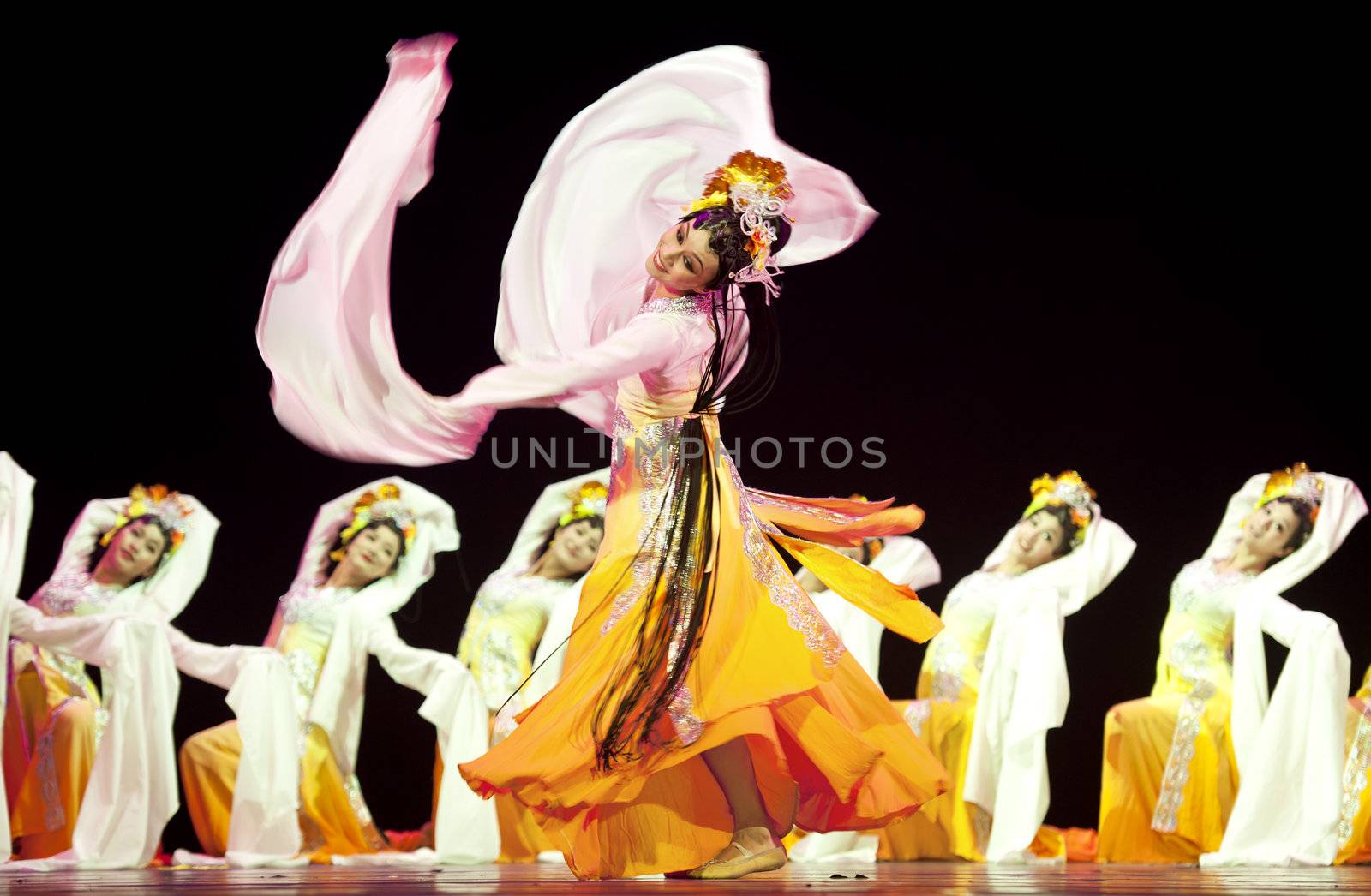 CHENGDU - OCT 17: Chinese national dancers perform folk dance on stage at JINCHENG theater on Oct 17, 2011 in Chengdu, China.