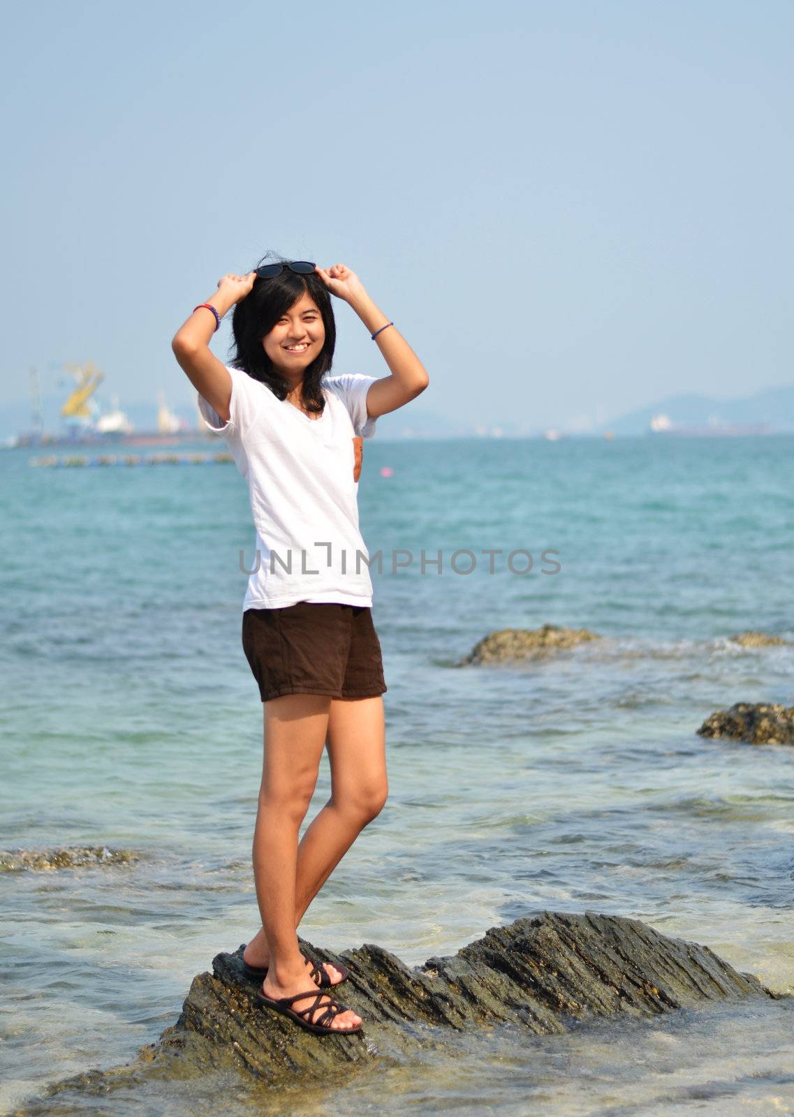 Beautiful girl smiling at the beach  by siraanamwong