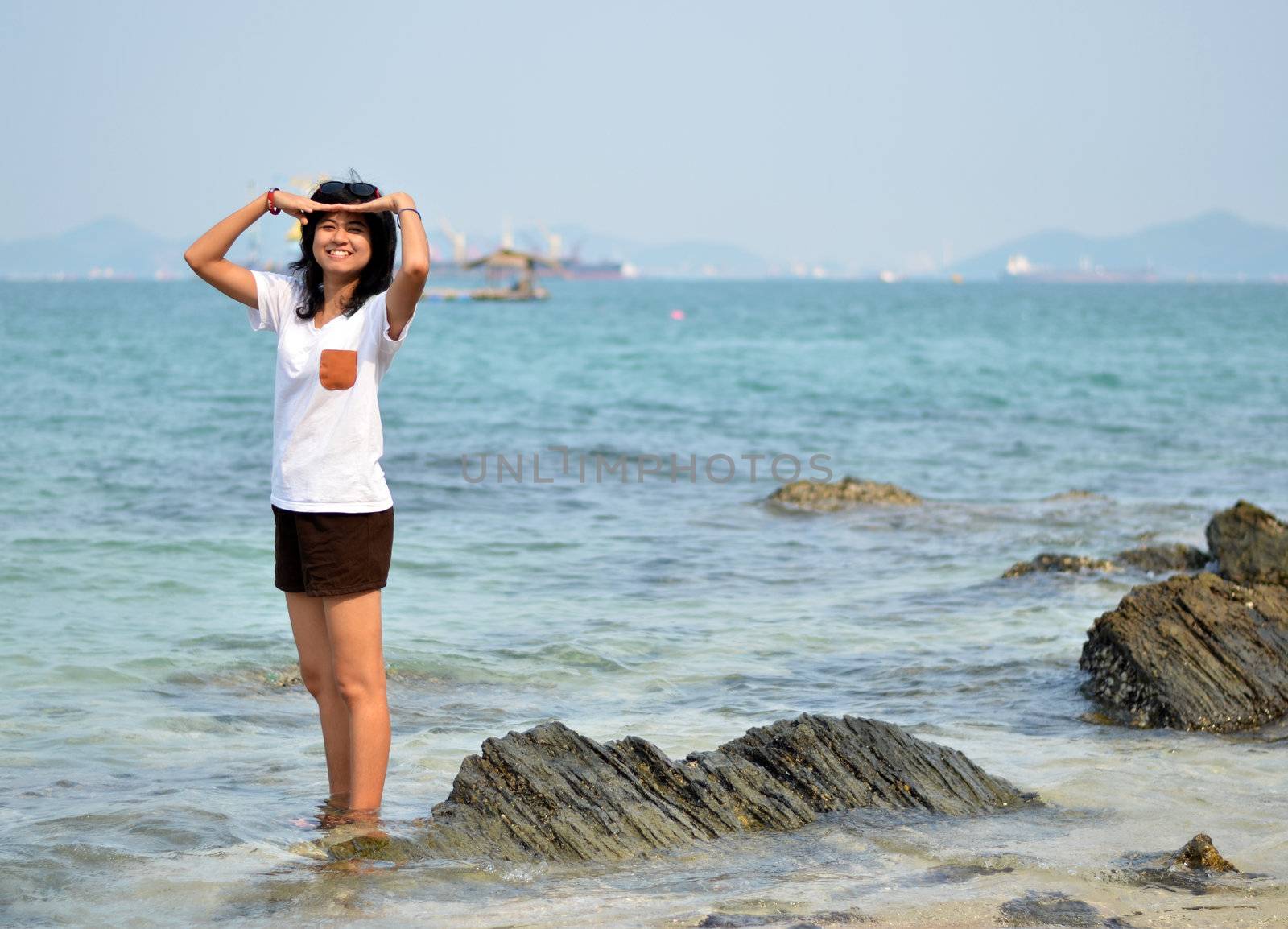 Beautiful young woman on beach summer holiday by siraanamwong