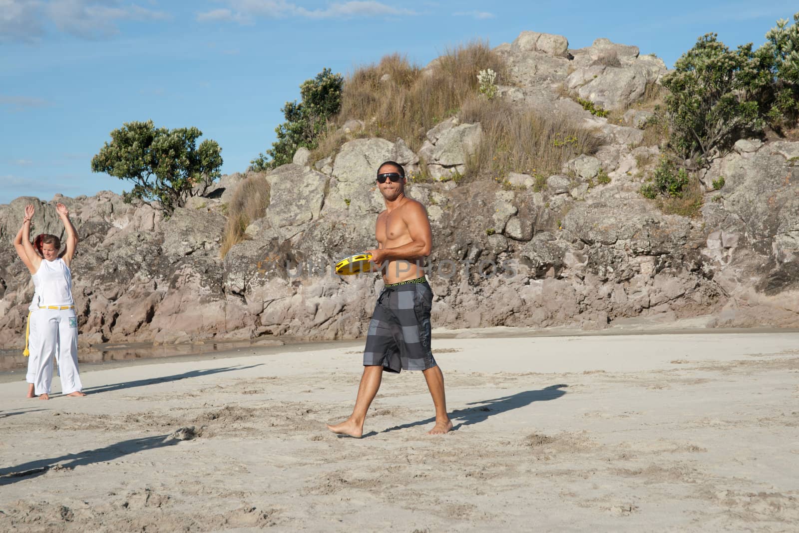 TAURANGA, NEW ZEALAND - JANUARY 23: Group of youths practice the art of capoeira on the Mount Maunganui beach, Tauranga New Zealand on January 23 2012. The sport, founded in Brazil is growing globaly.