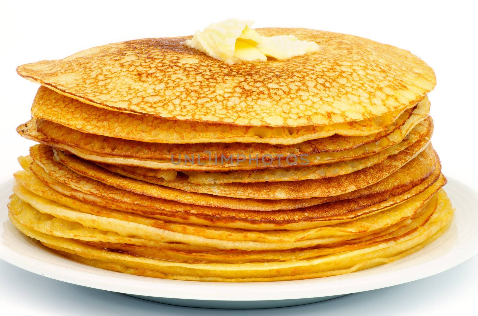 Big Stack of Delicious Thin Pancakes on White Plate closeup