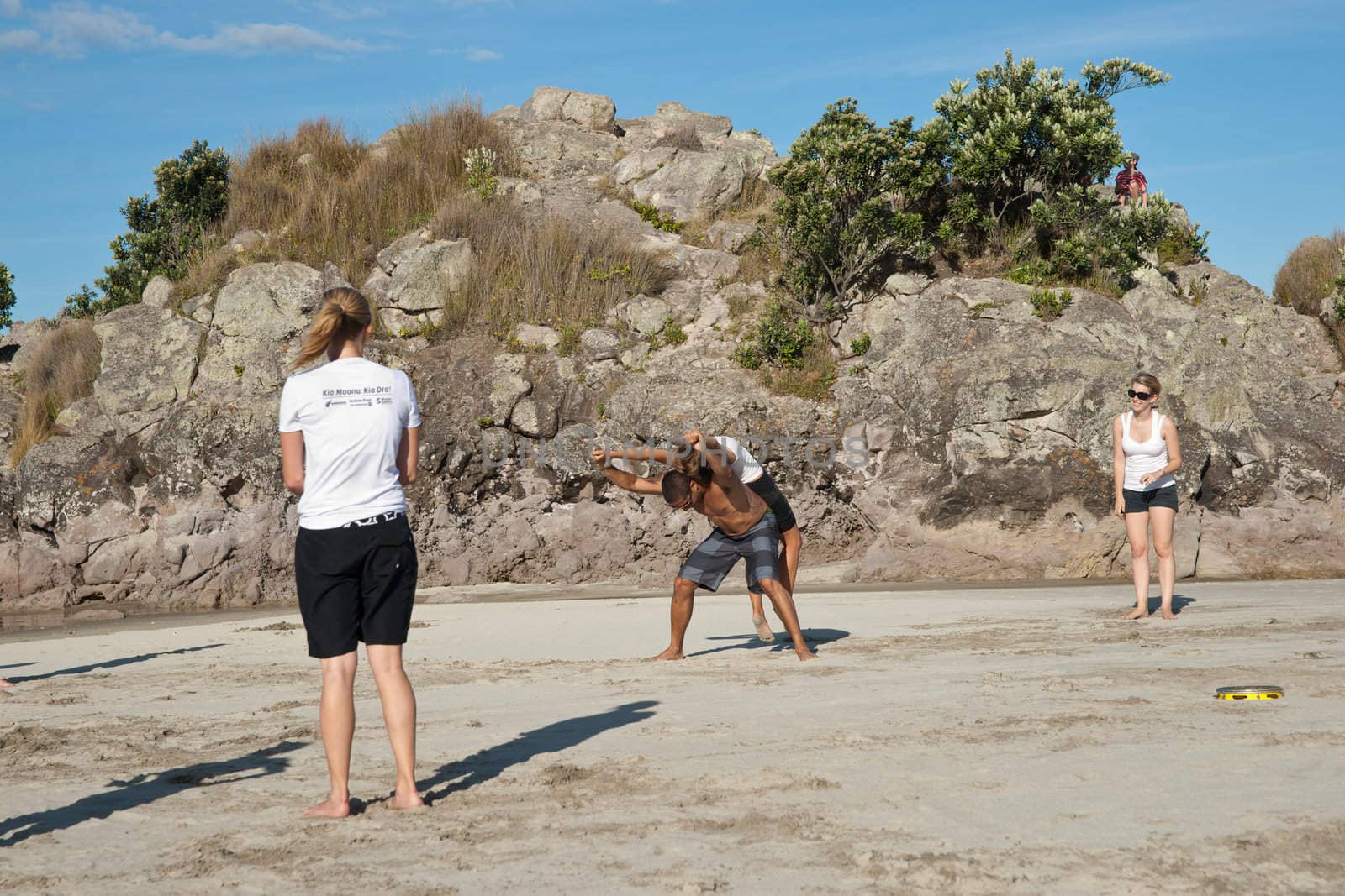 TAURANGA, NEW ZEALAND - JANUARY 23: Group of youths practice the art of capoeira on the Mount Maunganui beach, Tauranga New Zealand on January 23 2012. The sport, founded in Brazil is growing globaly.