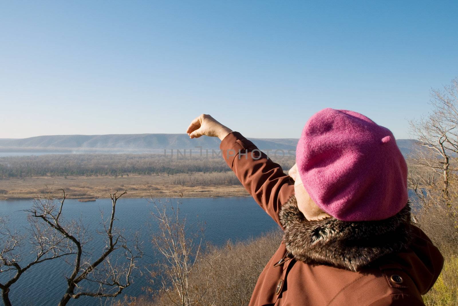 Woman holds a hand over the mountain