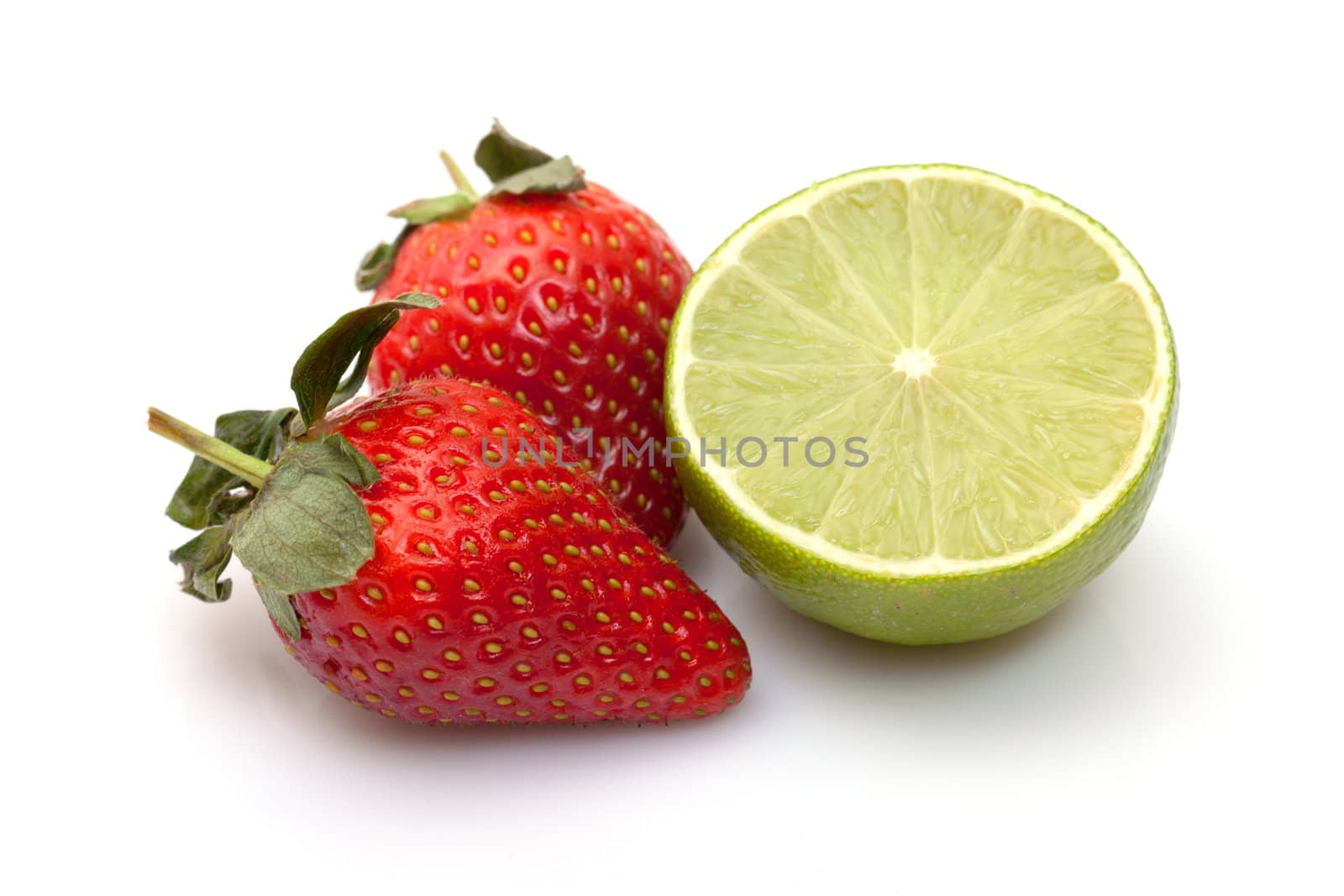 Strawberries with lime closeup over white background