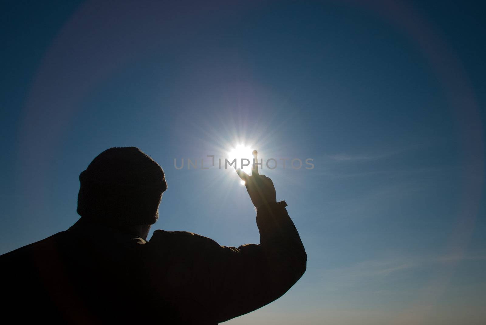 man holding a sun in his hands against the sky
