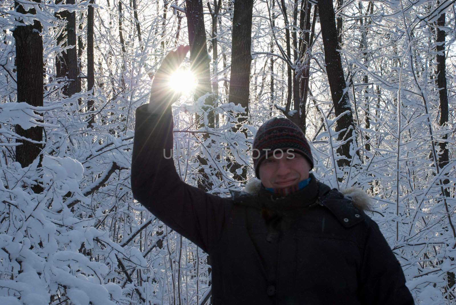 man holding a sun in his hands against the sky