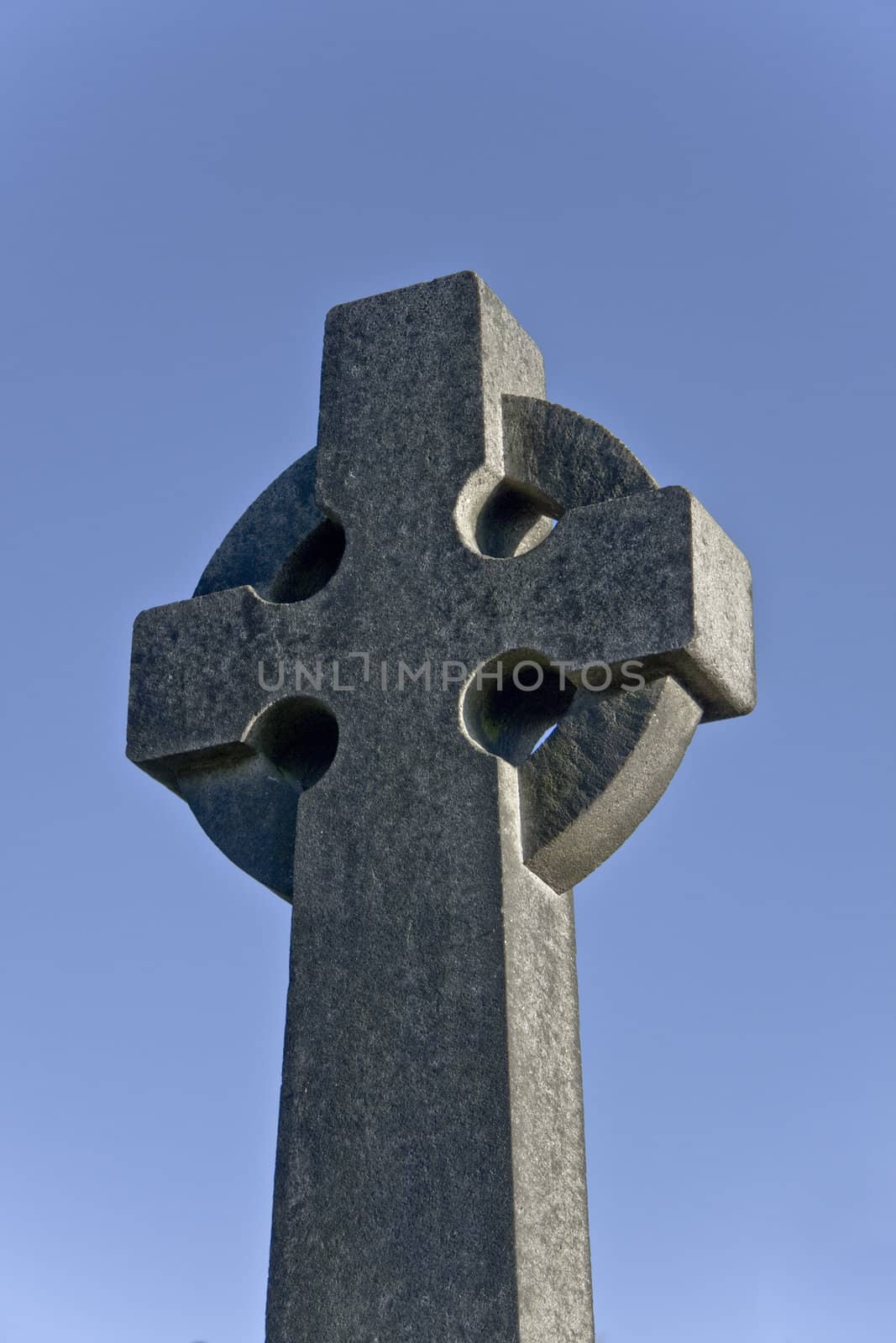 roughly-cut stone cross on cemetery in stirling