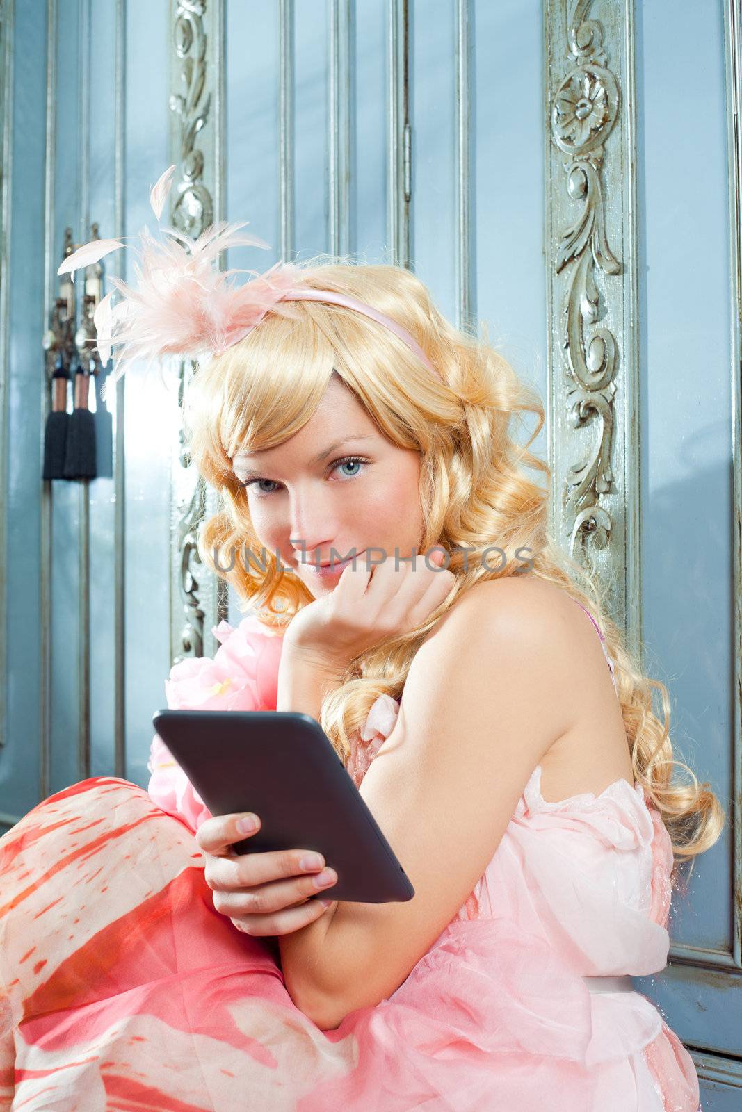 blond fashion princess woman reading ebook tablet with retro spring pink dress