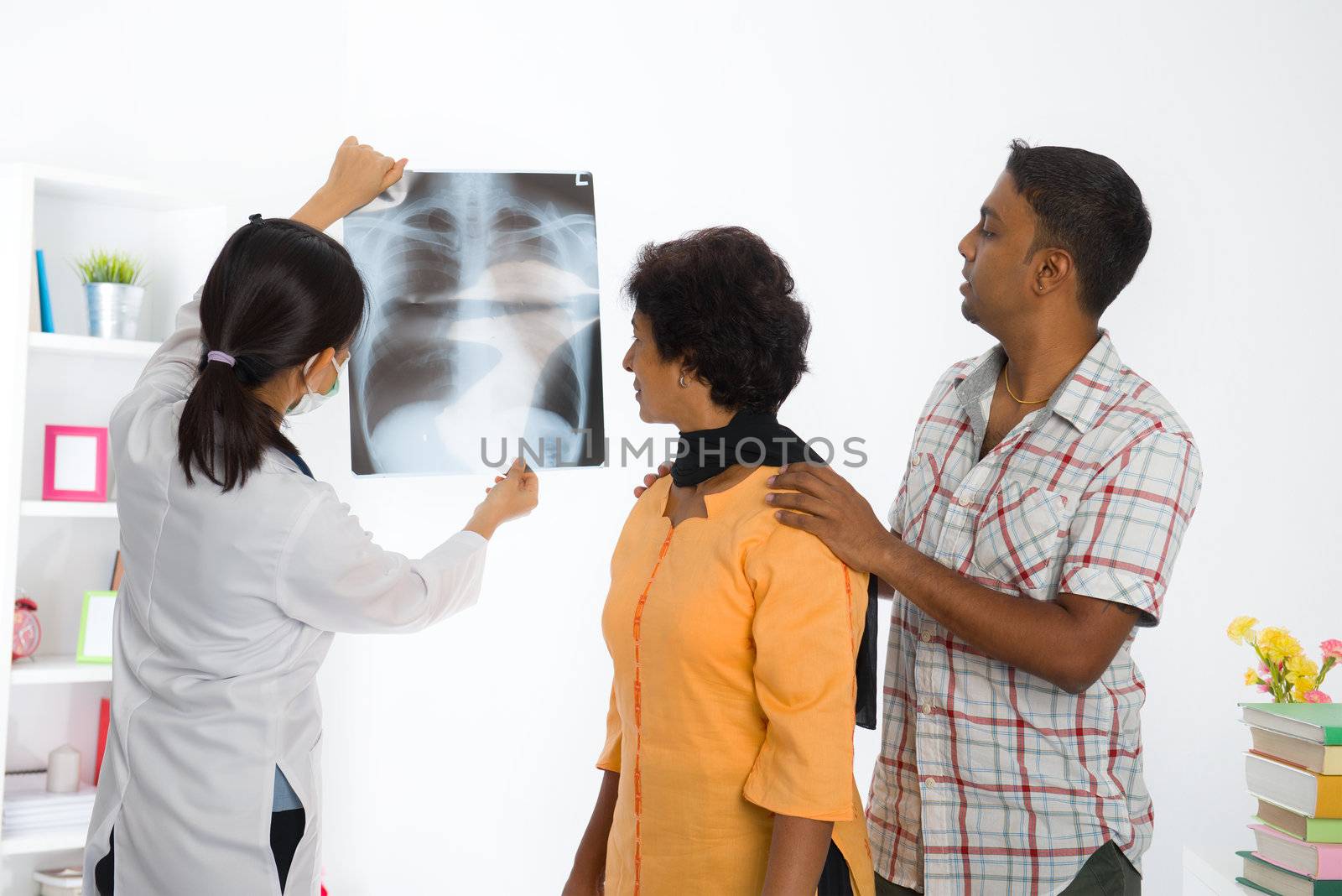 indian family senior female doing medical x-ray scan with asian doctor 